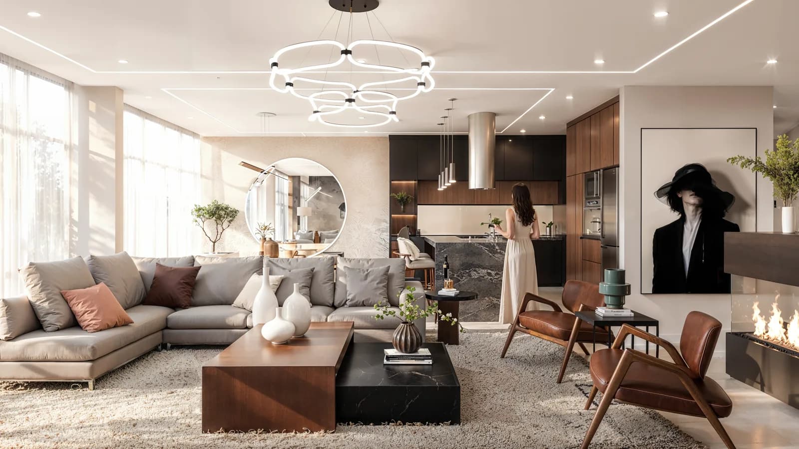 Render de la sala con sillones claros, lámpara de anillos y la cocina al fondo.